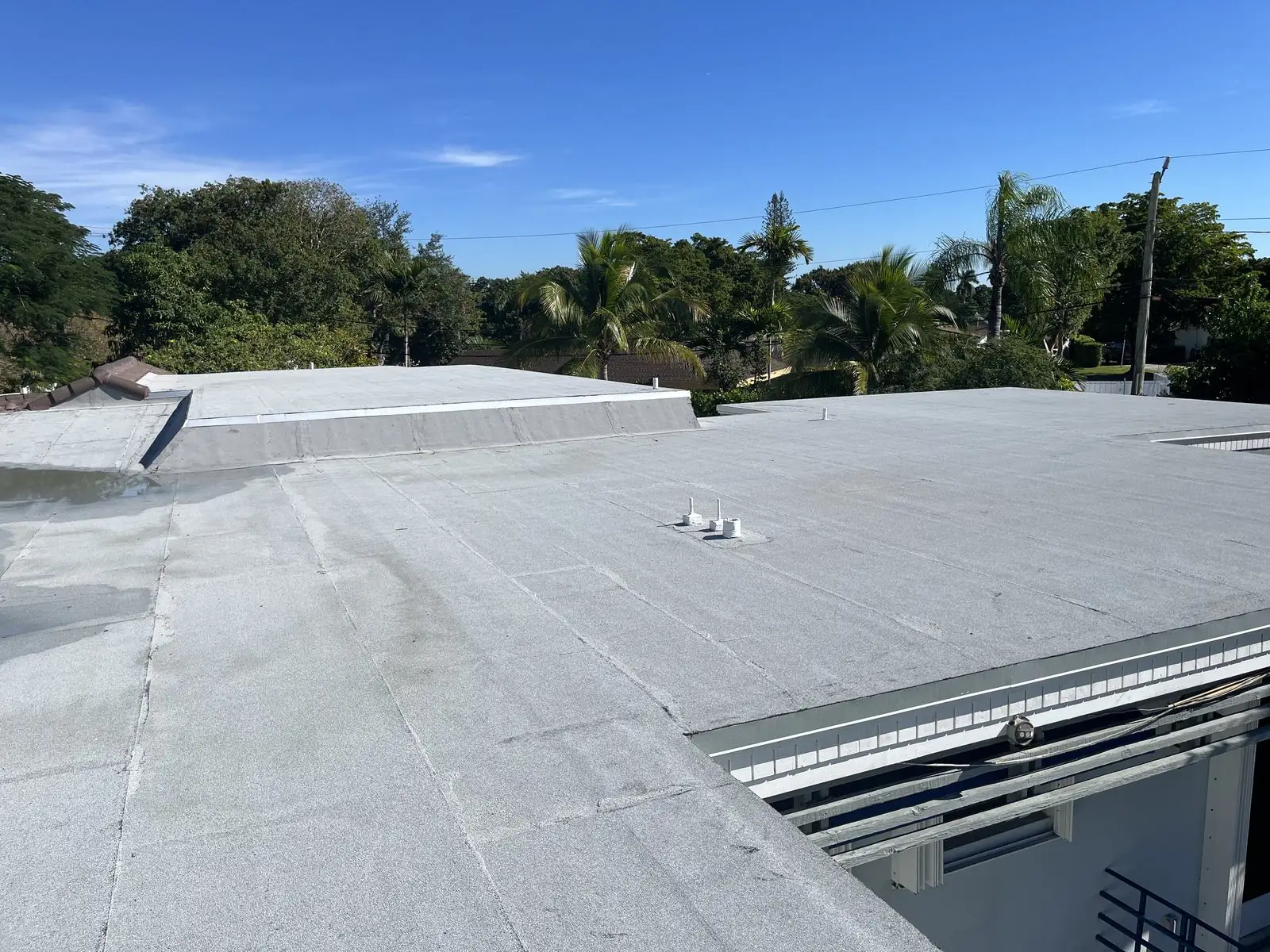 Low-slope flat roof next to a tile roof, RTI Roofing job