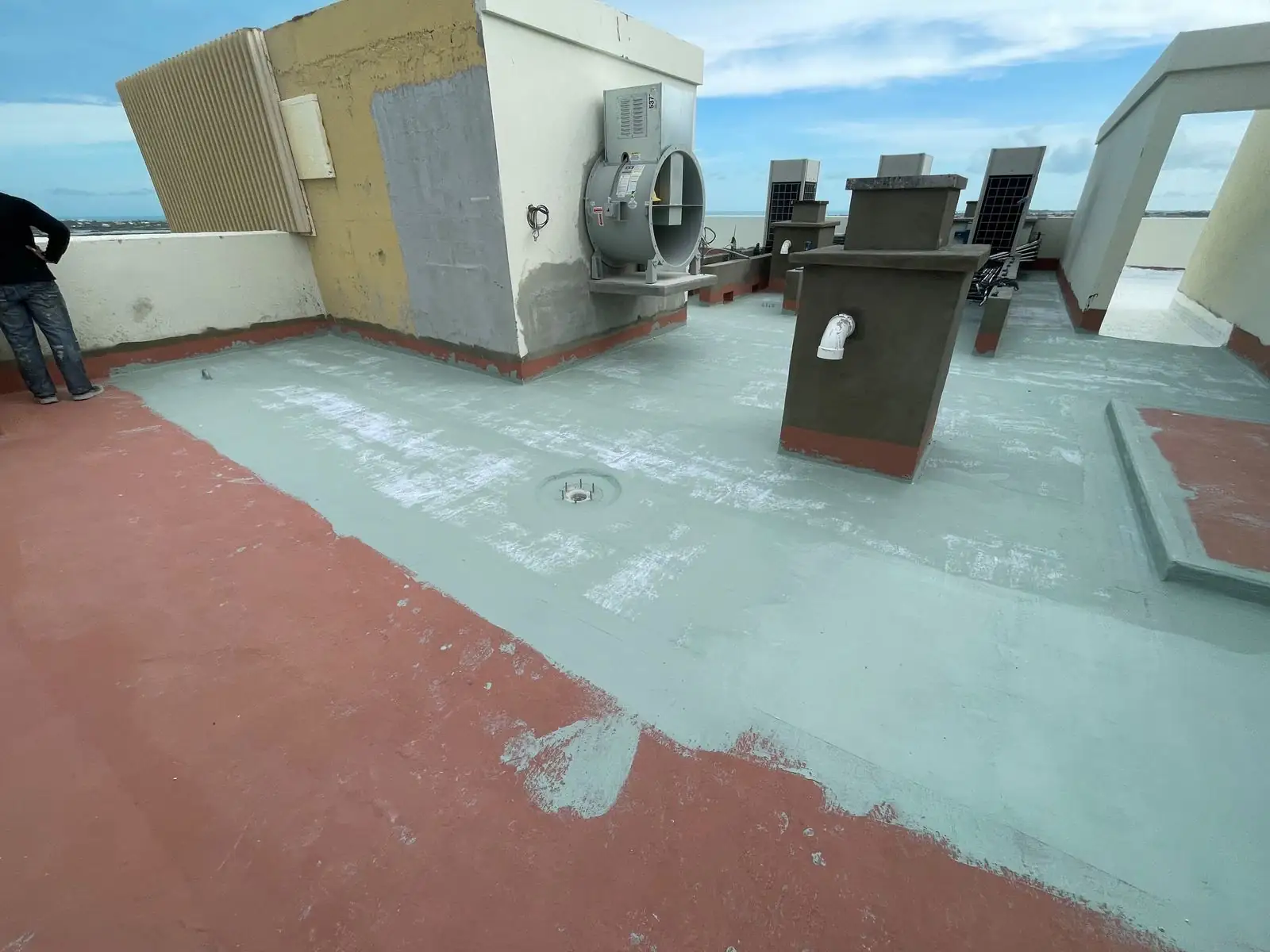 Grey coat over the red base around equipment curbs, St. Regis, Turks and Caicos