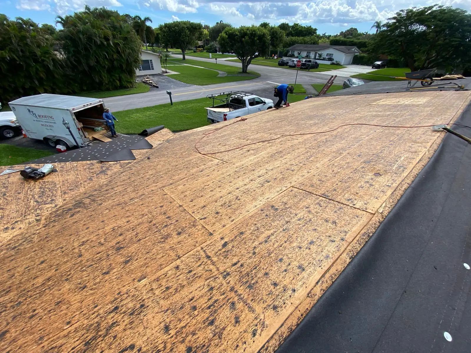 Roof replacement in progress with new wood decking, RTI Roofing